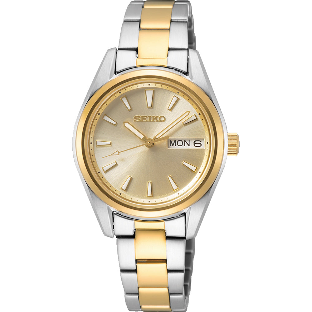 Het Seiko dameshorloge SUR354P1 heeft een gouden wijzerplaat met gouden uurmarkeringen en wijzers, aangevuld met een gouden lunette en zilvergouden schakelband. Met 10ATM waterbestendigheid en duurzaam saffierglas, geeft het dag-datumdisplay MON 6 aan, wat een mix van elegantie en veerkracht biedt.