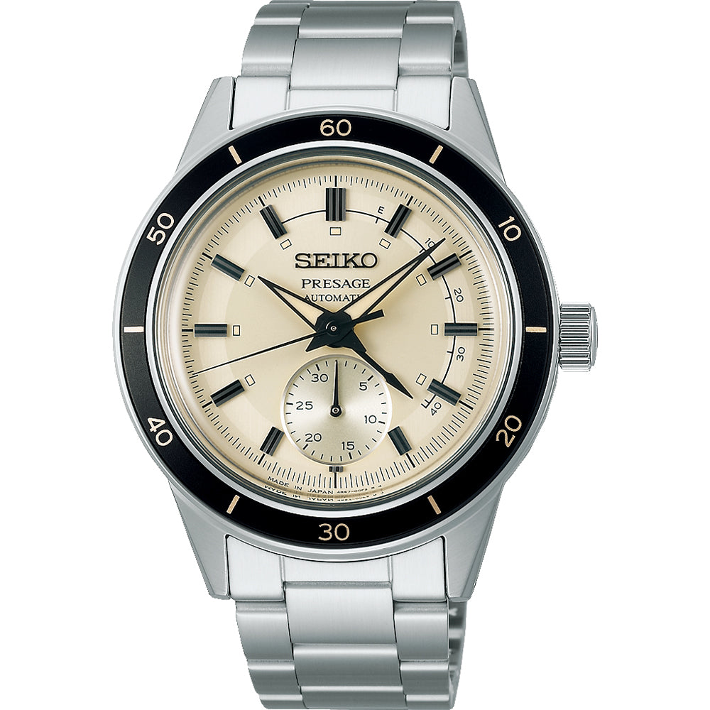 Heren horloge van Seiko Presage met een zilveren stalen band, een crème wijzerplaat en zwarte bezel.