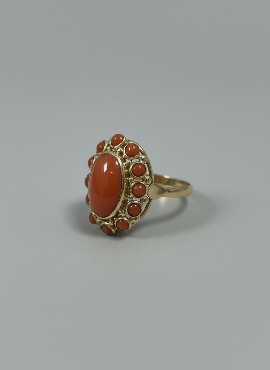 Vintage gouden ring van 14k met een grote ovale bloedkoraal en kleine bloedkoraal steentjes rondom.