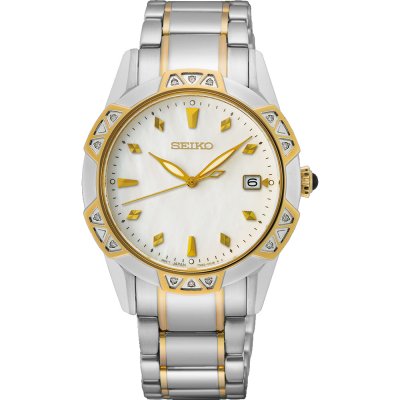 Dames horloge van staal met gouden accenten, witte wijzerplaat en diamantachtige details.