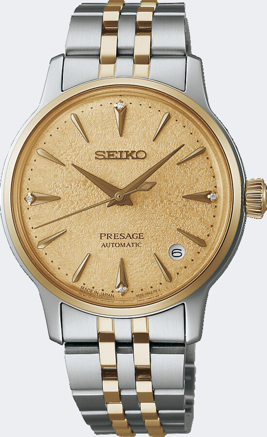 Twee-tonig horloge met een gouden wijzerplaat, zilveren en gouden band, en automatische beweging.