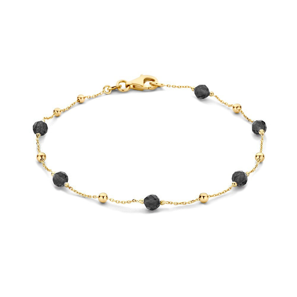 Geelgouden armband met zwarte lava- en gouden bolletjes, versierd met zirkonia.