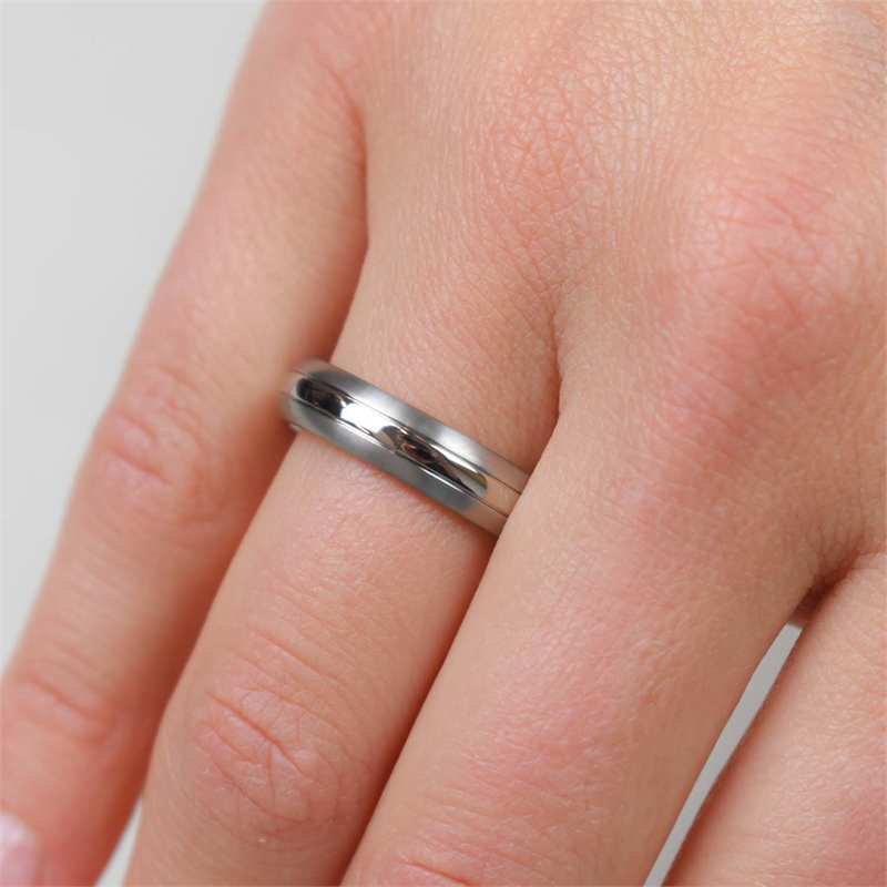 Een close-up van een hand met de Boccia Titanium Ring 0131-01 van Boccia aan de ringvinger tegen een lichte achtergrond.