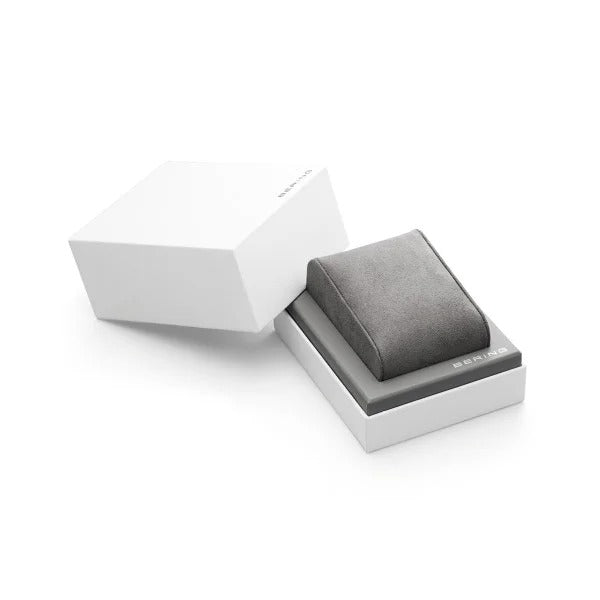 Een slanke witte rechthoekige doos met een los deksel onthult een grijs kussen binnenin, ideaal om de Bering 11020-004 dameshorloge of andere fijne sieraden in te etaleren.