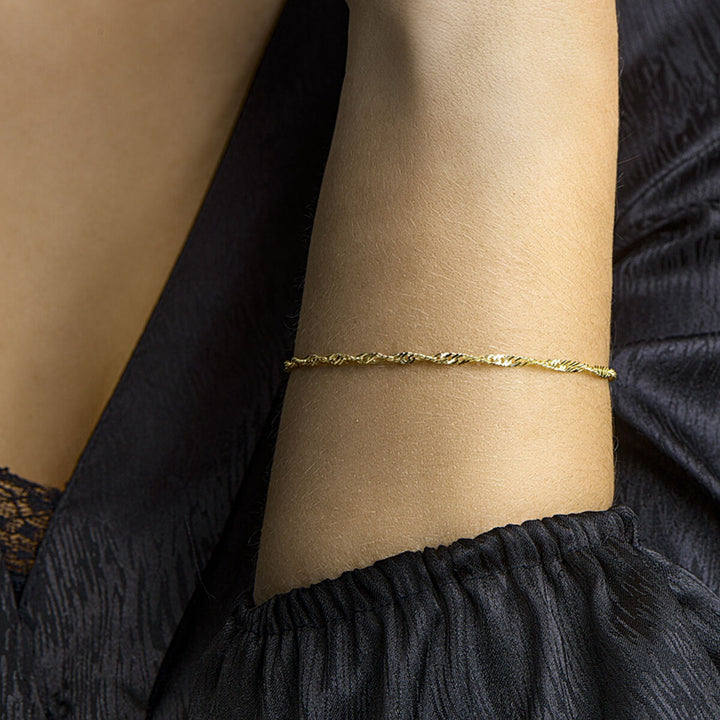 Gouden dames armband 9k met Singapore schakel