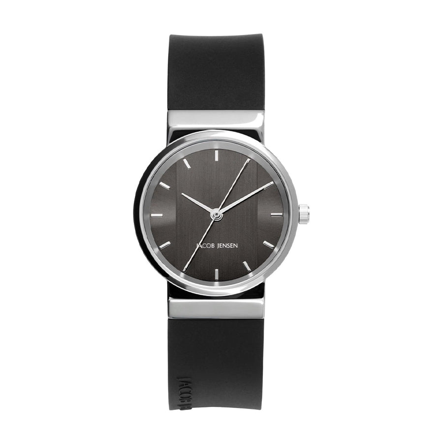 Zwart rubberen horloge met een ronde zilveren kast en een grijze wijzerplaat met streepjesindex.