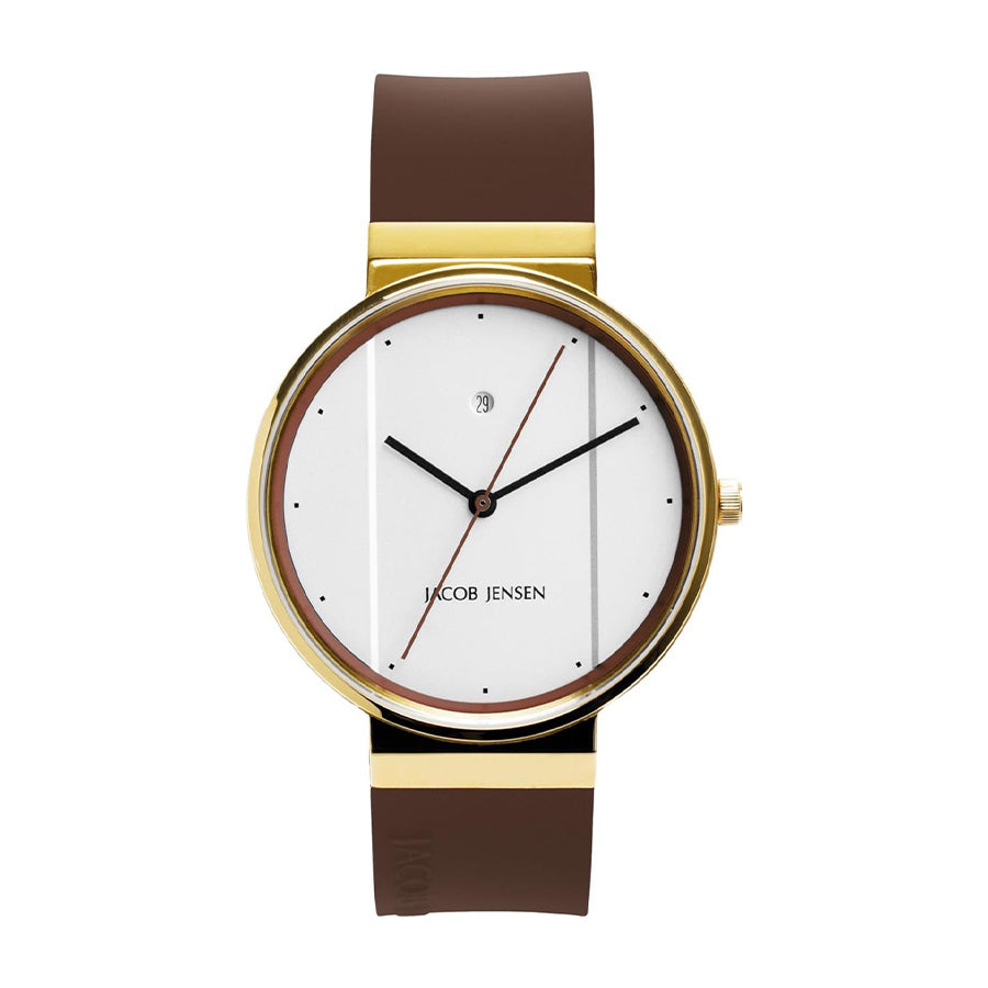 Gouden horloge met witte wijzerplaat, bruine rubberen band en minimalistische zwarte stippen als uurmarkeringen.