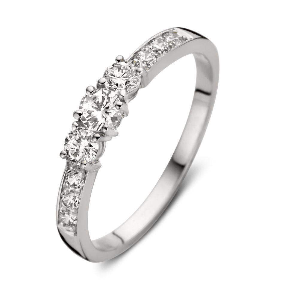 Witgouden ring met drie grote zirkonia's en kleinere zirkonia's aan de zijkanten.