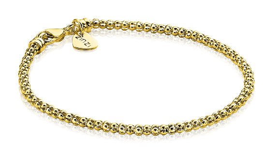 Gouden armband van bolletjes met een sluiting en een klein hartje.